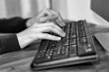 Black and white image of a business hands working and typing on laptop keyboard in office Royalty Free Stock Photo