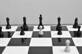 Black and white image of a chess board with pawn in front of black king