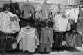 Black and White image of Children clothes hanging on hangers in the shop. Colourful kid blouses and shirt hanging on the cloth Royalty Free Stock Photo