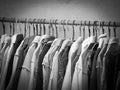 Black and white image of clothes hanging on hanger rack. Choice of fashion clothes on hangers Royalty Free Stock Photo