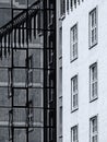 Black and white image of contrast of old and modern architecture with reflection Royalty Free Stock Photo