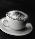 Black and white image of cup of cappuccino