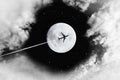 Black and white image of dark sky, white clouds and full moon with silhouette aircraft for travel and tourism presentation and