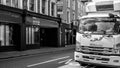 Black and White Image Delivery Lorry Parked Opposite A Retail Business To Let With No People Royalty Free Stock Photo