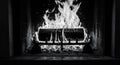A black and white image depicts a classic fireplace with a single log burning in t Royalty Free Stock Photo