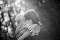 Black and white image of a happy smiling young mother hugging he Royalty Free Stock Photo