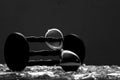 Sand clock on broken glass pieces in blur. Royalty Free Stock Photo