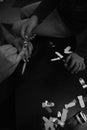 Black and white image of a little girl helping her mom to put on nail stickers