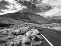 Black and white image of long car road going through dry desert to volcano Teide peak, Tenerife, Canary island Royalty Free Stock Photo