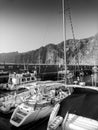 Black and white image of luxurious yachts moored in ocean bay at Los Gigantes, Tenerife island