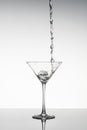 Black and White image of a Martini glass with liquid pouring into it Royalty Free Stock Photo