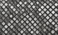 A black and white image of a mesh pattern with white and black diamond shapes. Royalty Free Stock Photo