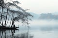 Black and white image of morning nature, a boat with a fisherman on a lake, bamboo trees, soft fog. Royalty Free Stock Photo
