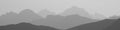 Black and white image of mountain peaks in the morning light