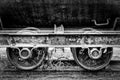 A black and white image of old vintage rusty railway coal cart wheels Royalty Free Stock Photo