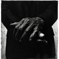 Black and white image of an old woman\'s hands on a black background Royalty Free Stock Photo