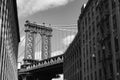 Black and White Photo of the Manhattan Bridge between Old Brick Buildings in Dumbo Brooklyn New York Royalty Free Stock Photo