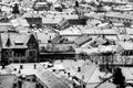 Black and white image of roofs covered by snow