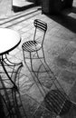 two chairs at an outdoor table facing each other in black and white Royalty Free Stock Photo