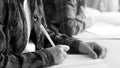 Black and white image of two teenage girls writing homework in copybooks Royalty Free Stock Photo