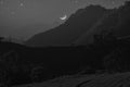 Black and white image of waning moon over the mountain Royalty Free Stock Photo