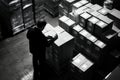 Black and white image of warehouse worker using barcode reader to scan packages on pallet Royalty Free Stock Photo