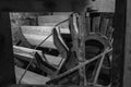 A black and white image of the wheel of a watermill in Devon, England, taken from the right of the wheel