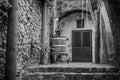 Black and white image with wine press and closed doors. Old Ital Royalty Free Stock Photo