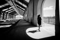 black and white image of a woman under the architectural arch of the old train station in the City of Barreiro