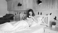 Black and white image of young woman drinking coffee in bed at morning Royalty Free Stock Photo