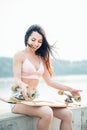 Casual blond female in denim shirt posing on stairs with longboard Royalty Free Stock Photo