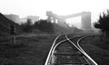 Black and white industrial landscape with railway rails