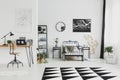 Black and white interior design of bright kid`s bedroom with laptop on desk Royalty Free Stock Photo