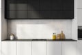 Black and white kitchen cabinet with concrete backsplash