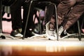 Black and white lace tennis shoes and chairs on brown wood stage