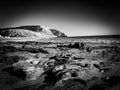 Black and white landscape featuring a rocky shoreline Royalty Free Stock Photo