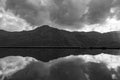 Black and White Landscape Of Mountain with Lake Reflection and Dramatic Clouds