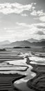 Black And White Landscape: Serene River And Land With Mountains In The Distance