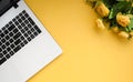 Black-white laptop keyboard, yellow flowers on an orange background. Flat lay. Top view. Copy space Royalty Free Stock Photo