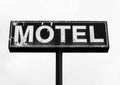 Black and white large dilapidated and peeling motel sign
