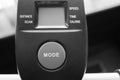 Black and white of large mode button on exercise equipment