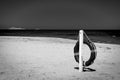 Black and white of lifebuoy on a deserted beach