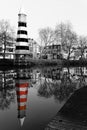 Black and white; Lighthouse in Breda, reflection in the river in color