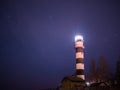 Black and white lighthouse at night in Baltic sea beach Royalty Free Stock Photo