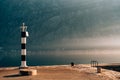 Black and white lighthouse in the sea. Prcanj, Kotor Bay, Monten Royalty Free Stock Photo