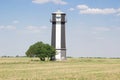 Black and white lighthouse stands on clear field. summer wallaper Royalty Free Stock Photo