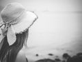 Black and white lonely and depressed woman standing in front of the sea