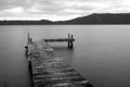 Black and white long exposure jetty boat ramp water lake hills landscape