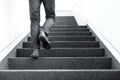 Low angle picture of man walking upstairs on indoors Royalty Free Stock Photo