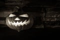 Black and white luminous halloween Jack O' lantern in dark on stone background Royalty Free Stock Photo